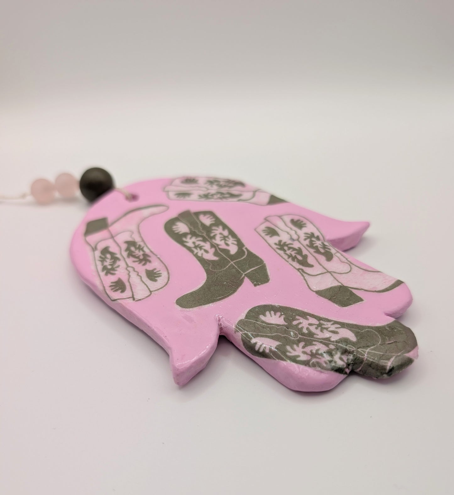 Hamsa wall art in pastel pink with olive cowboy boots